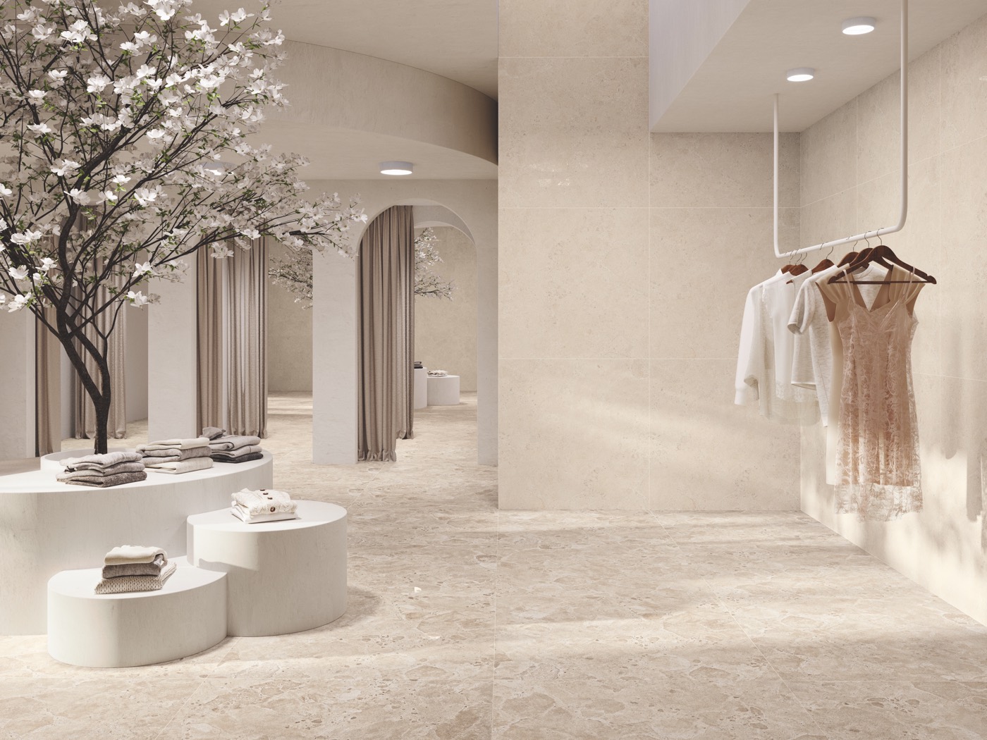 Tienda de moda con arcos y pavimento y revestimiento efecto piedra en tono arena