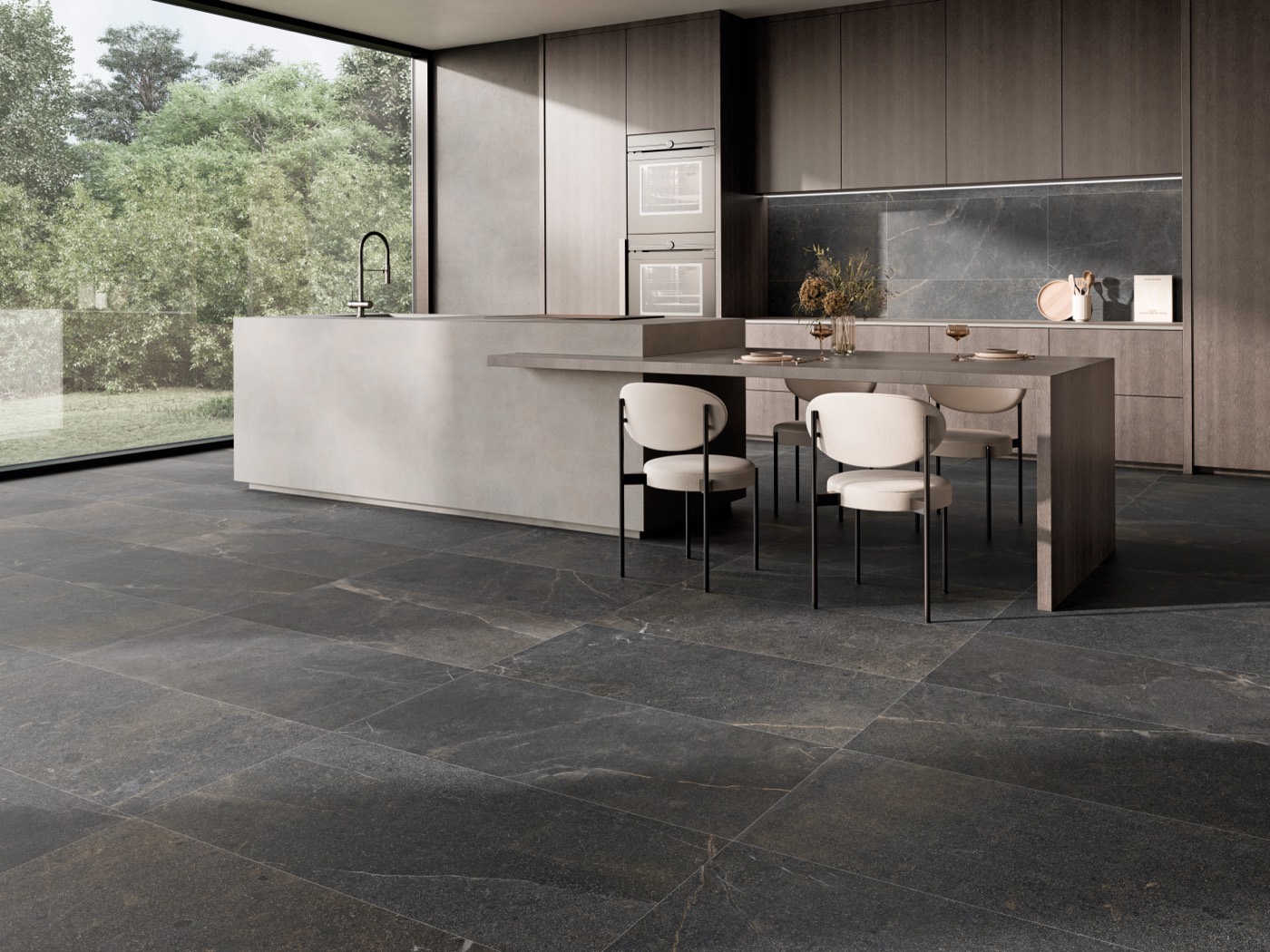 Cocina abierta con pavimento efecto piedra gris oscuro de gran formato